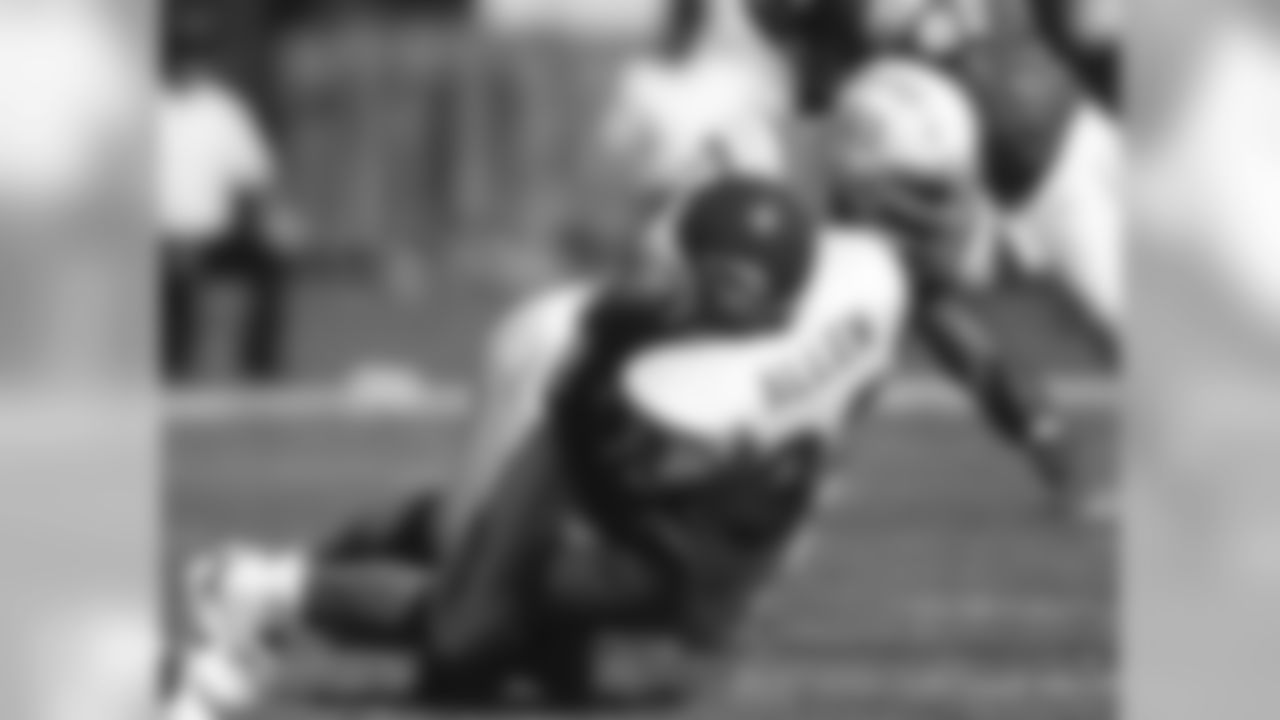 Chargers linebacker Junior Seau takes down Chiefs running back Marcus Allen on October 9, 1994. The Chargers defeated the Chiefs 20-6.