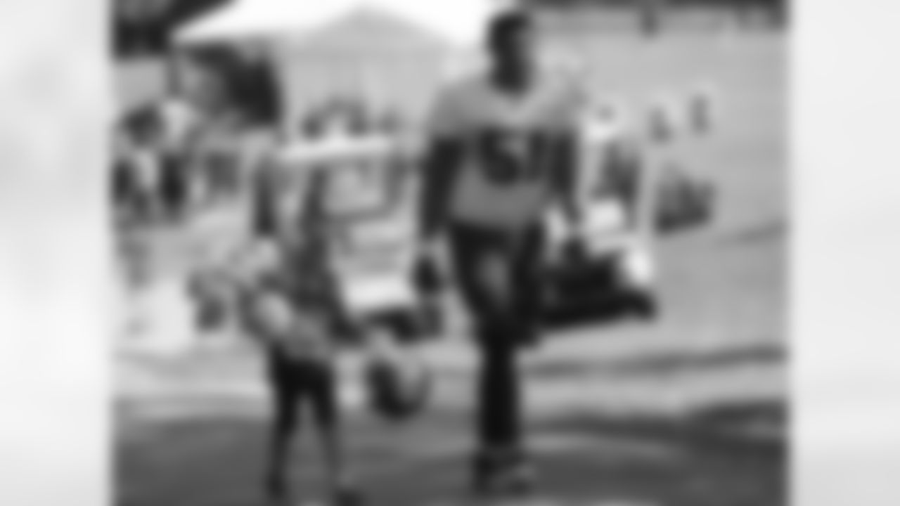 Kansas City Chiefs defensive lineman Frank Zombo (51) walks with a young fan after practice on the fourteenth day of training camp on Mosaic Life Care Field at the campus of Missouri Western State University on Wednesday, August 17, 2016.