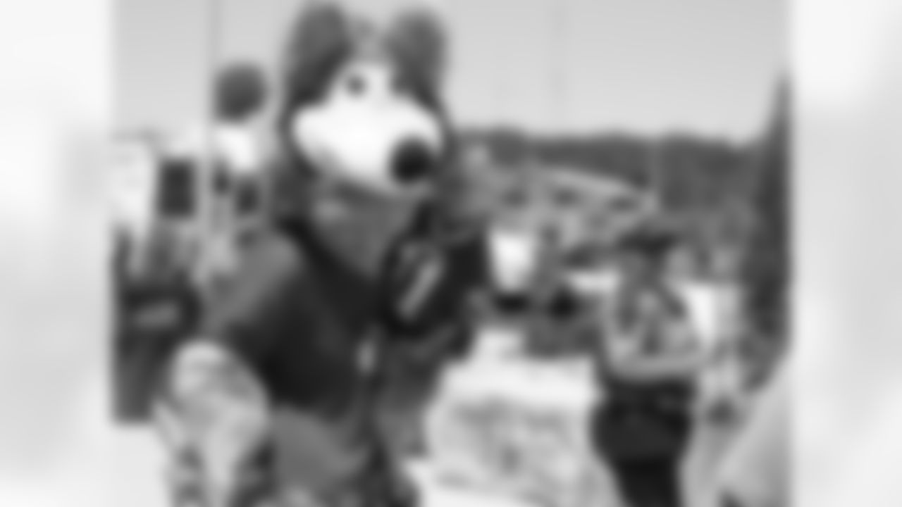 KC Wolf poses for a picture with a fan prior to the first preseason game against the Seattle Seahawks at Arrowhead Stadium on Saturday, August 13, 2016.
