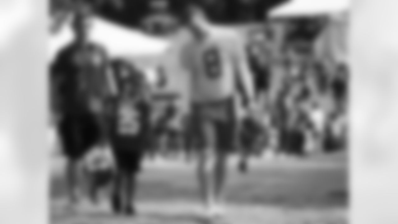 Kansas City Chiefs quarterback Kevin Hogan (8) walks with a young fan after practice on the ninth day of training camp on Mosaic Life Care Field at the campus of Missouri Western State University on Monday, August 8, 2016.