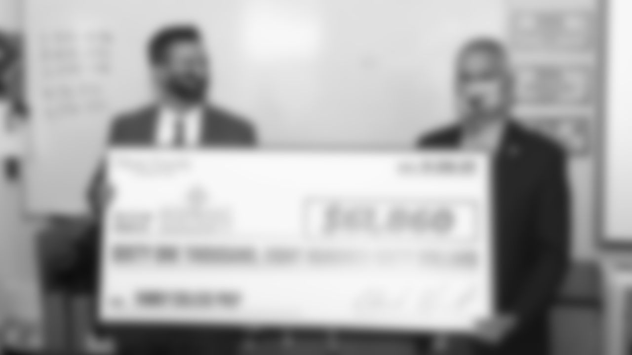 The Kansas City Chiefs visit Guadalupe Centers High School and present a check to the Greater Kansas City Hispanic Development Fund.