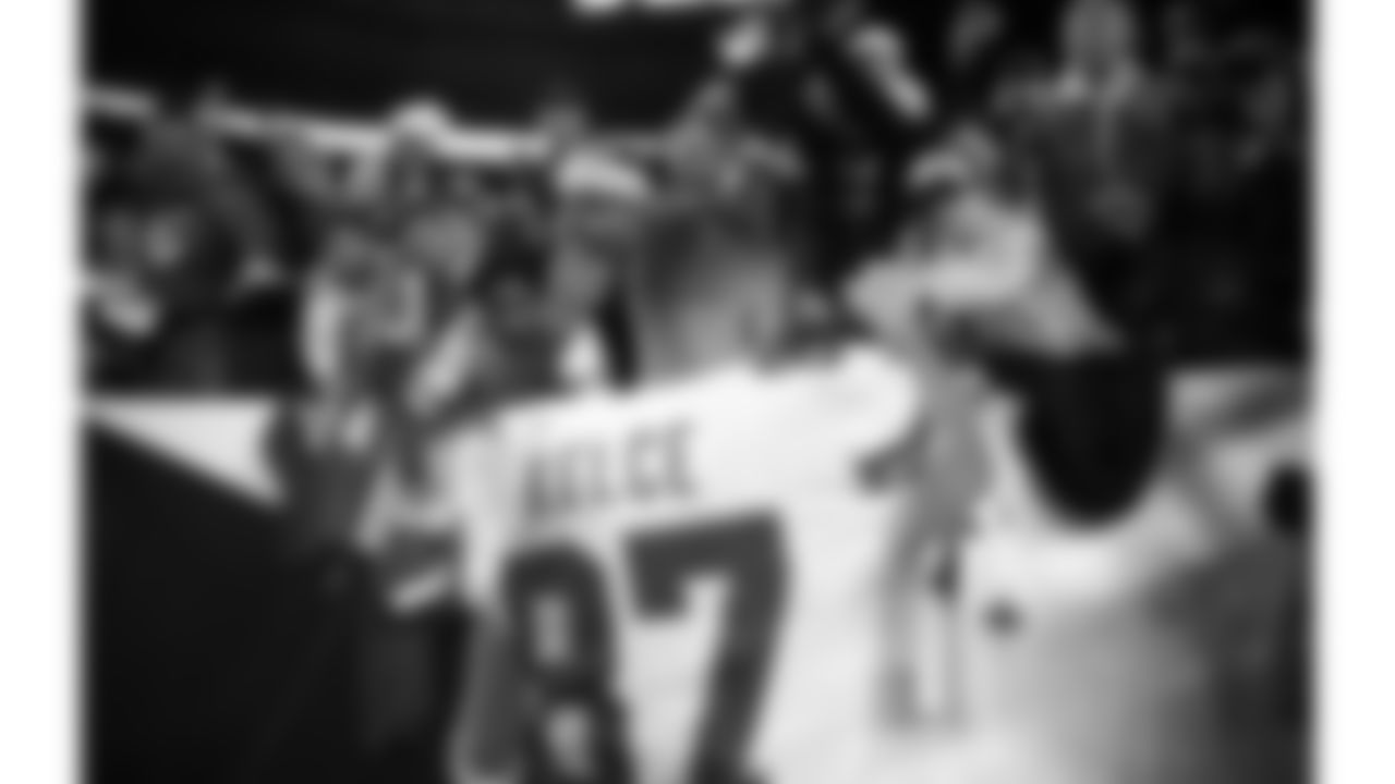 Kansas City Chiefs tight end Travis Kelce (87) high-fives fans after an NFL football game against the Denver Broncos, Sunday, December 11, 2022 in Denver.