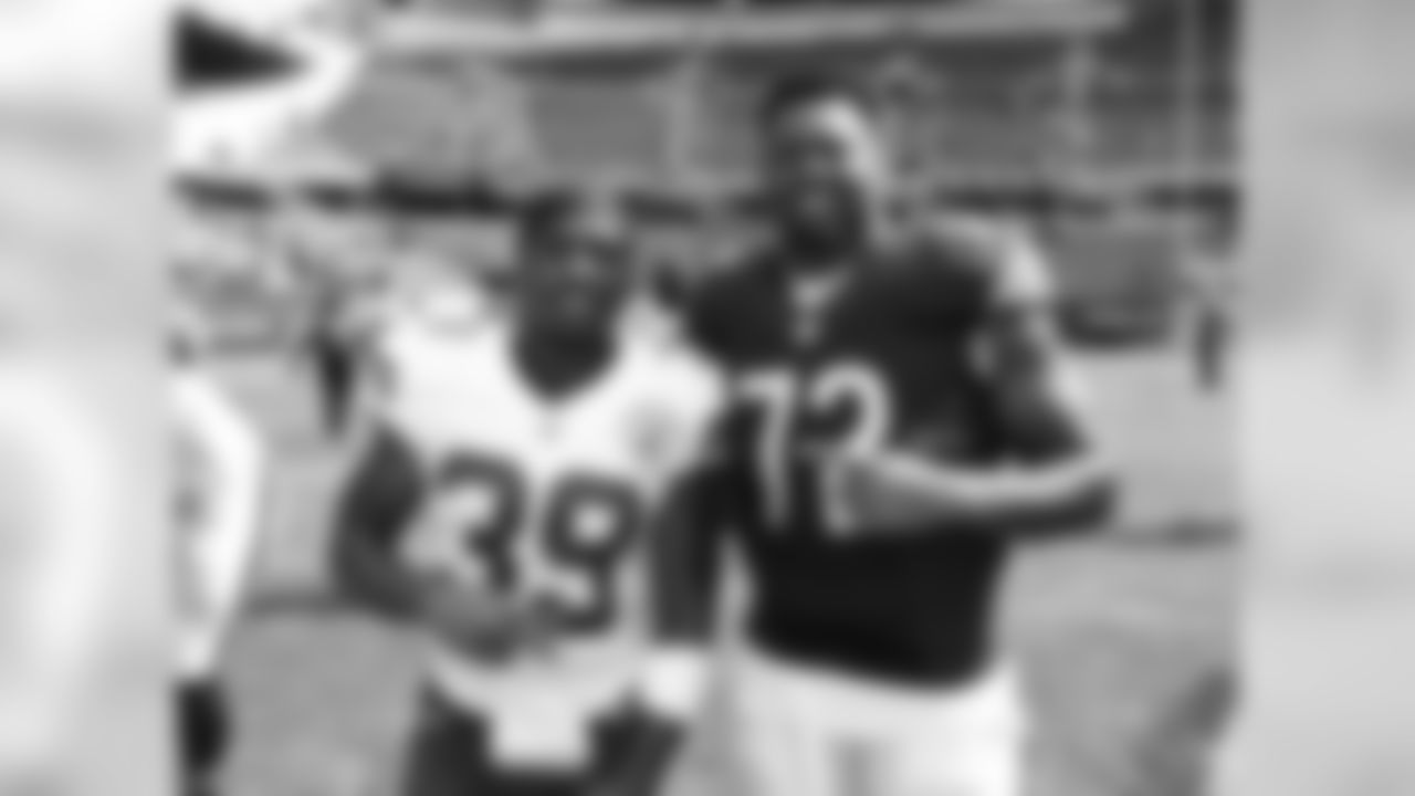 Kansas City Chiefs defensive back Jeron Johnson (39) poses for a picture with Chicago Bears offensive lineman Charles Leno (72) after the preseason game, Saturday, August 27, 2016, in Chicago, Illinois.
