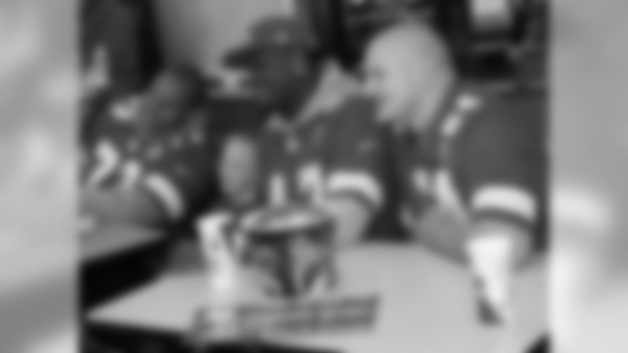 Demetrius Harris, Eric Kush and Jon Asamoah sign autographs in support of First Downs for Down Syndrome at a KFC in Kansas City.