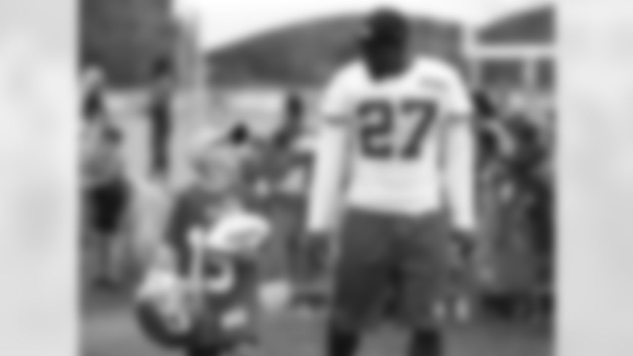 Kansas City Chiefs defensive back Stevie Brown (27) walks up the hill with a young fan after practice on the fifth day of training camp on Mosaic Life Care Field at the campus of Missouri Western State University on Wednesday, August 3, 2016.
