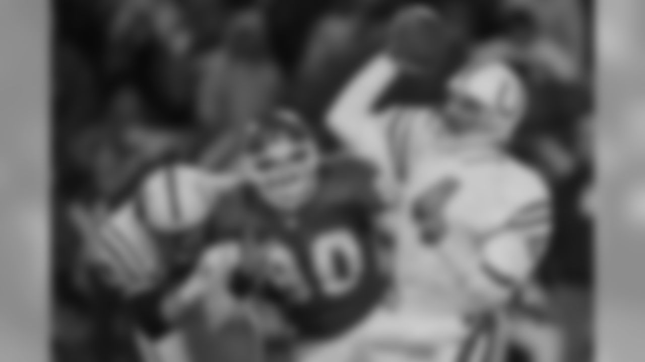 Colts QB Jim Harbaugh tries to get off a pass under pressure from Chiefs defender Neil Smith, during the fourth quarter of the AFC divisional playoff game in Kansas City on January 7, 1996. The Chiefs lost 10-7.