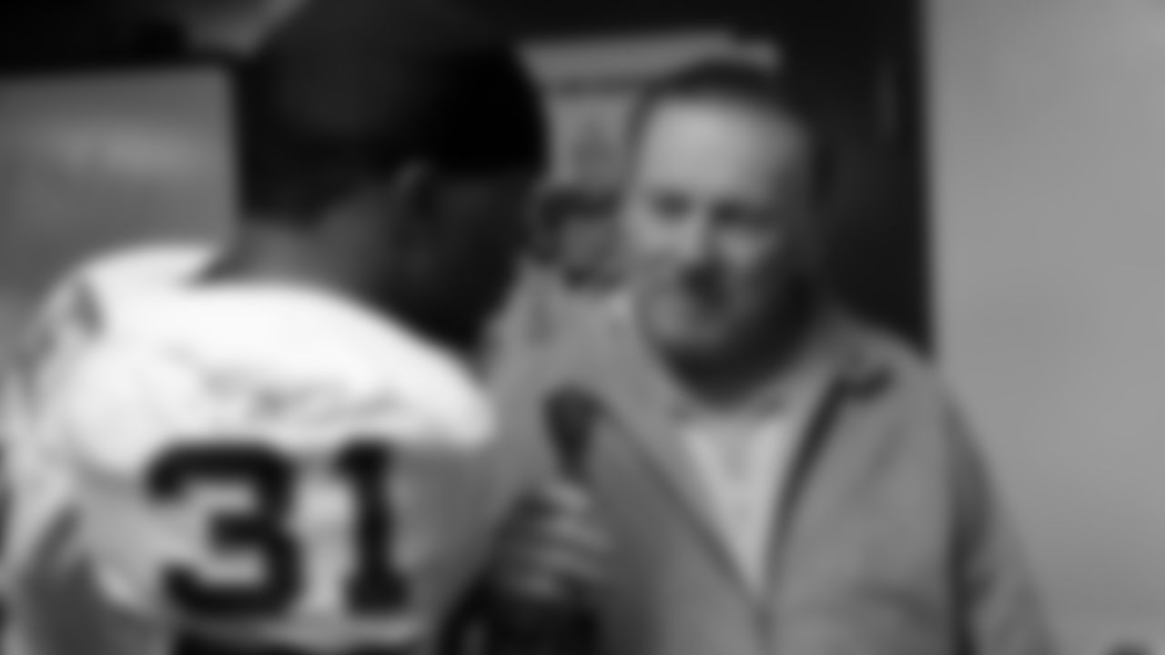 Len Dawson (16) interviews a player after a game for 101 The Fox.