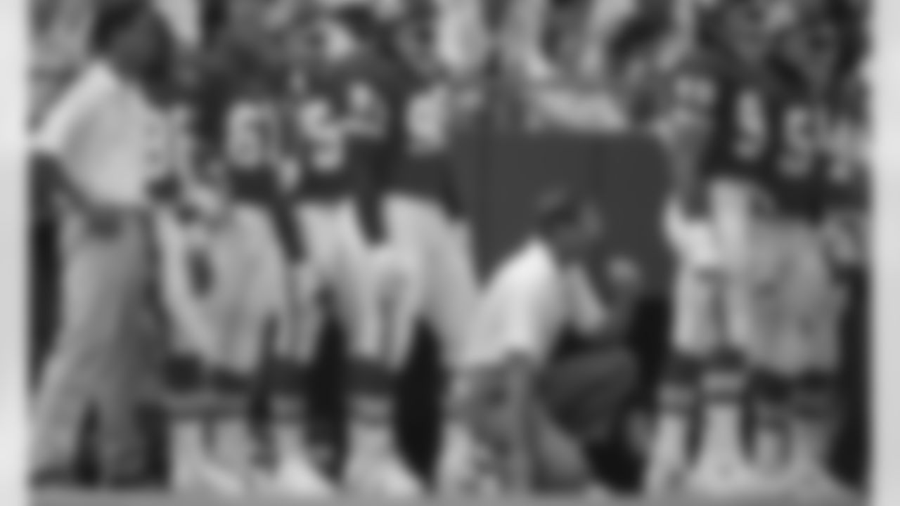 Kansas City Chiefs head coach Marty Schottenheimer kneels on the sideline during a 1991 NFL game.