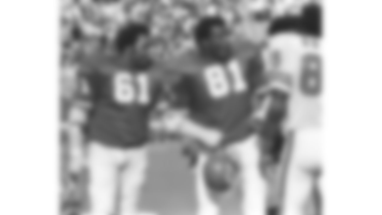 Kansas City Chiefs players Curley Culp (61) and Marvin Upshaw (81) talk to players from the opposing team during a game at Arrowhead Stadium in 1974.