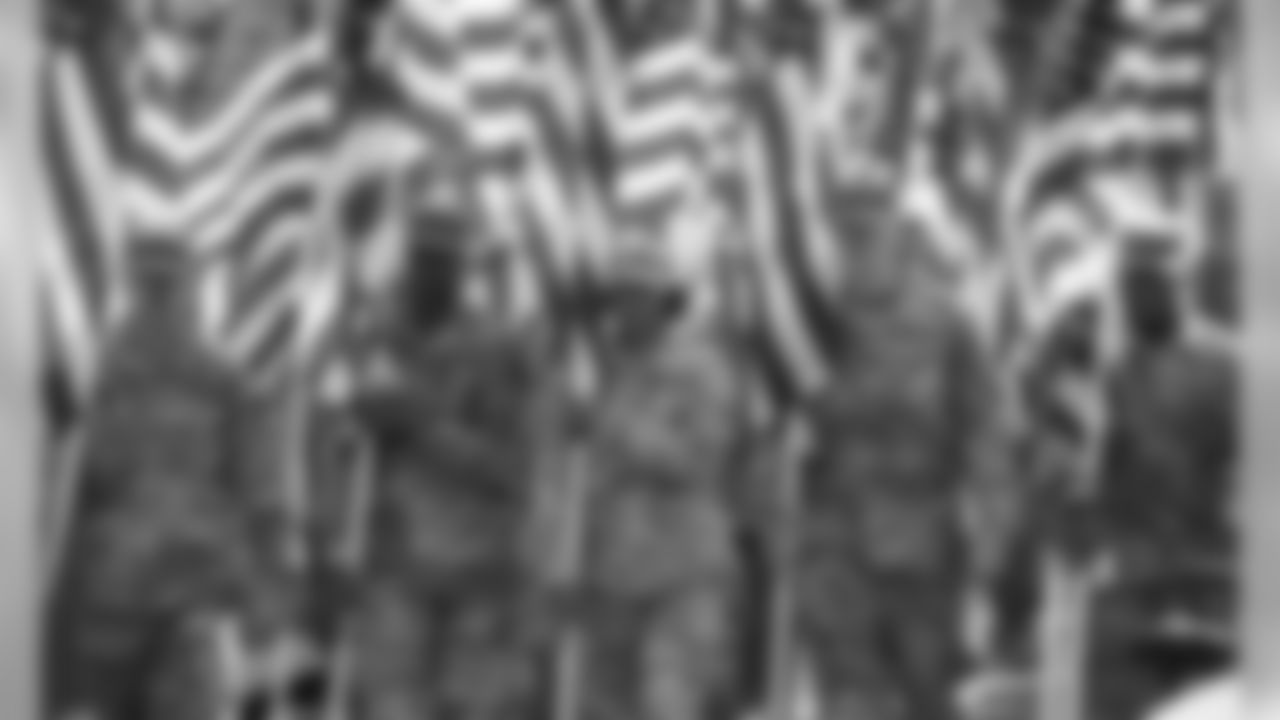 Members of the US Military hold American Flags during a game against the Arizona Cardinals on November 11, 2018