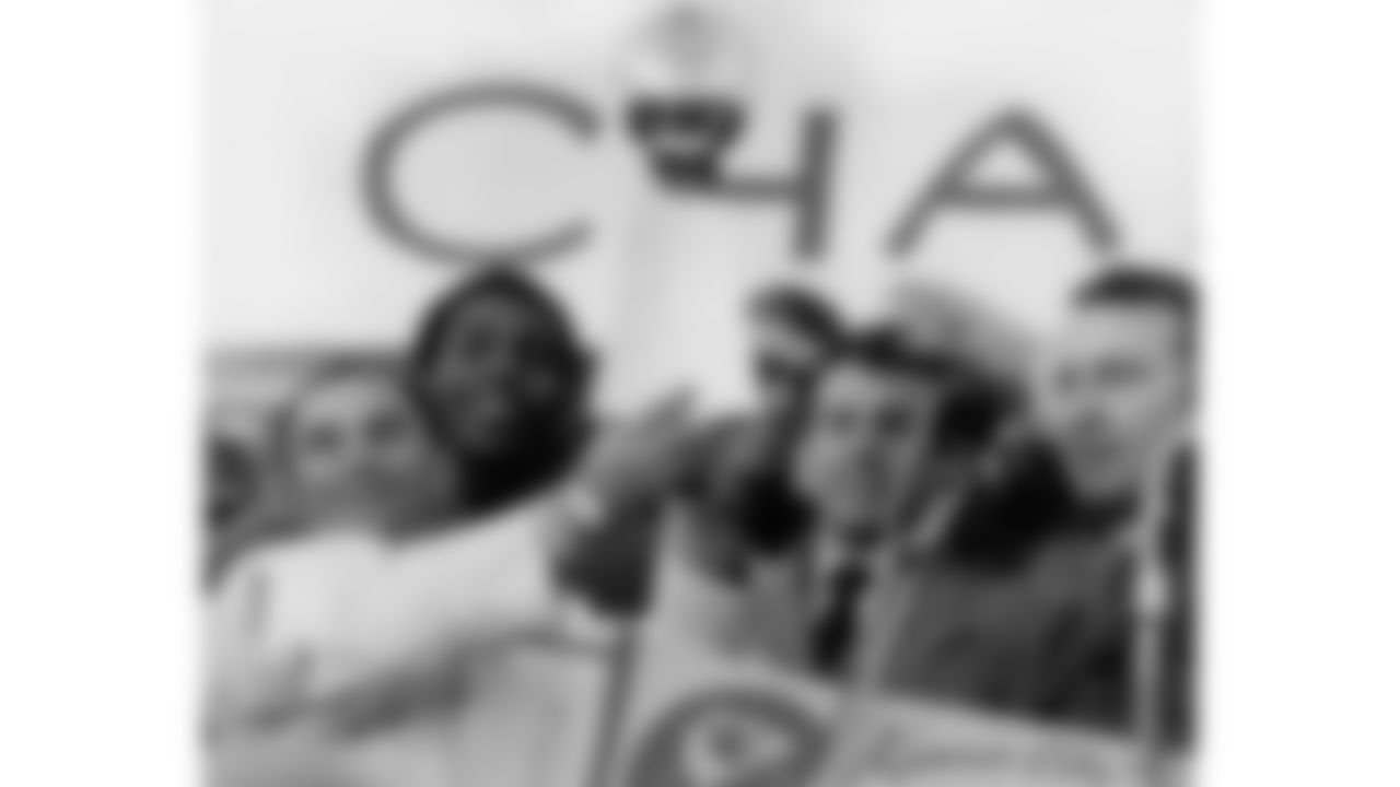 Hank Stram, Len Dawson and other Chiefs pose with the Super Bowl trophy during the parade for winning Super Bowl IV.