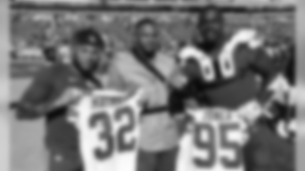 Kansas City Chiefs Safety Tyrann Mathieu (32) and Defensive Tackle Chris Jones (95) pose with Oakland Raiders Safety Johnathan Abram (24) after the game between the Kansas City Chiefs and the Oakland Raiders at Oakland-Alameda County Coliseum in Oakland, CA.
