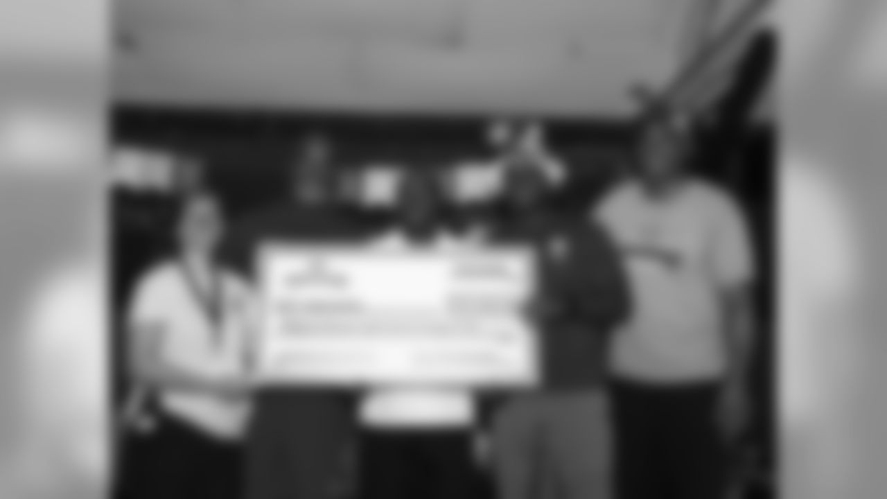 Chiefs ambassadors make a check presentation to Camp Quality and participate with the campers in a Play 60 activity.