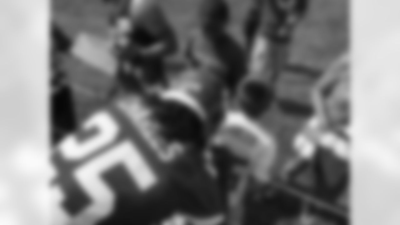 Jamaal Charles signs a jersey.