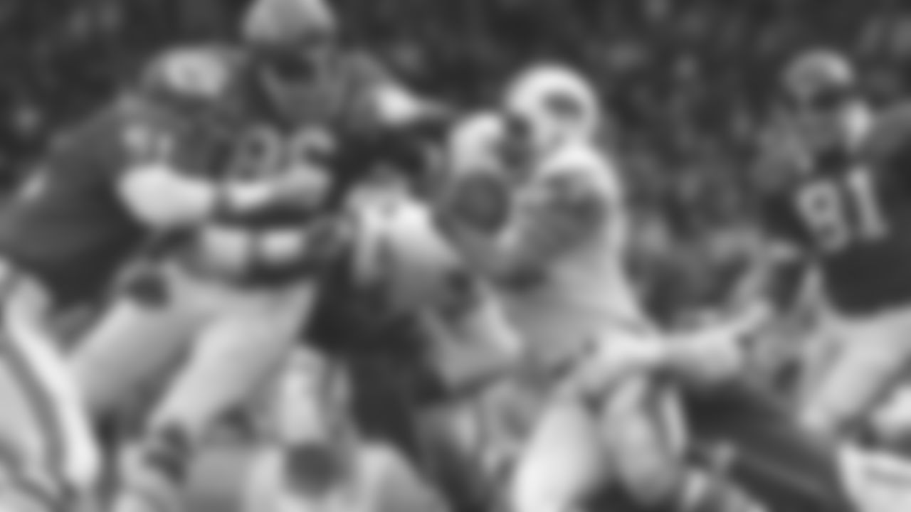 Kansas City Chiefs defensive players Jim Lynch (51) and Buck Buchanan (86) tackle Buffalo Bills running back O.J. Simpson during a muddy 1970 game against the Buffalo Bills.