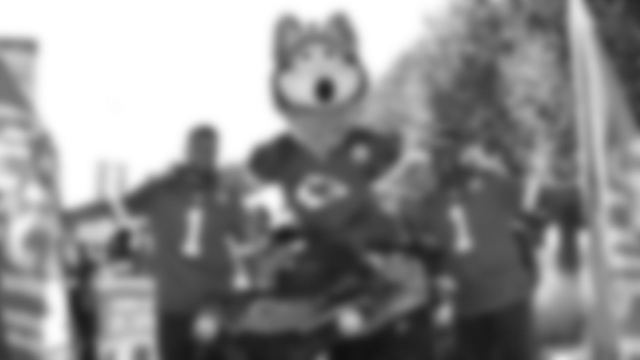 Kansas City Chiefs flag runners and KC Wolf take a photo before the parade prior to an NFL football game against the Green Bay Packers, Sunday, November 7, 2021 in Kansas City.