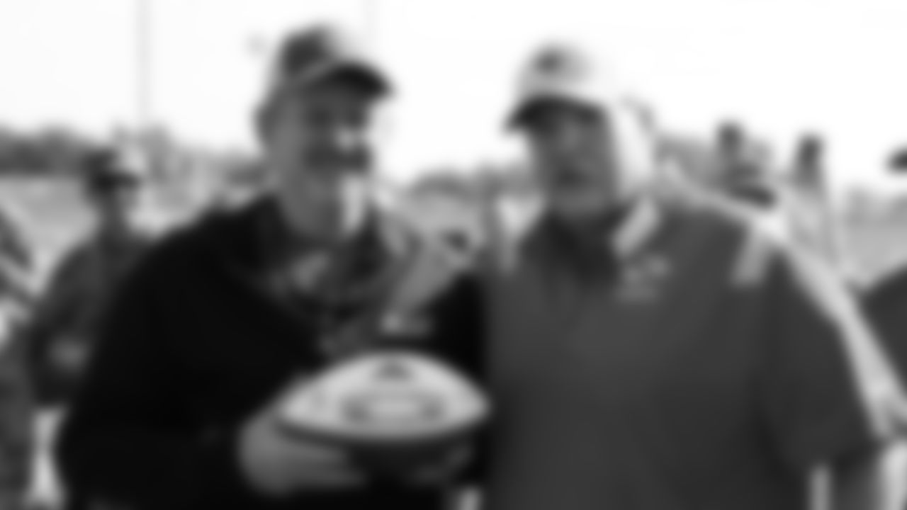 Major Mark Nutsch receives a game ball from Kansas City Chiefs Head Coach Andy Reid after training camp practice at Missouri Western State University.