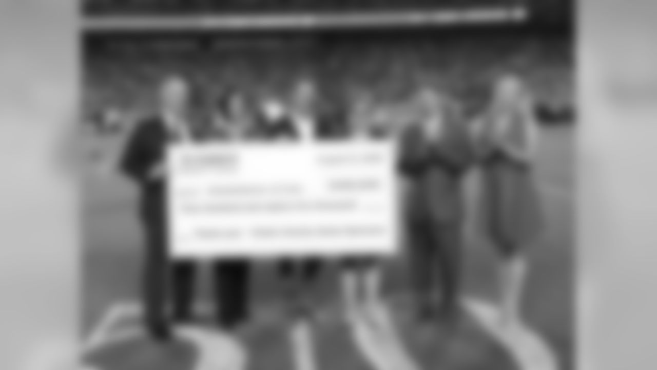 Clark Hunt presents a check to Cornerstones of Care during Texans at Chiefs at Arrowhead Stadium on 8/9/18.
