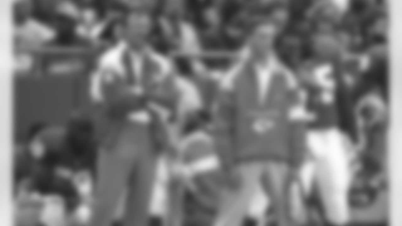Kansas City Chiefs head coach Marty Schottenheimer stands on the sideline with his son Brian during a 1991 NFL game.
