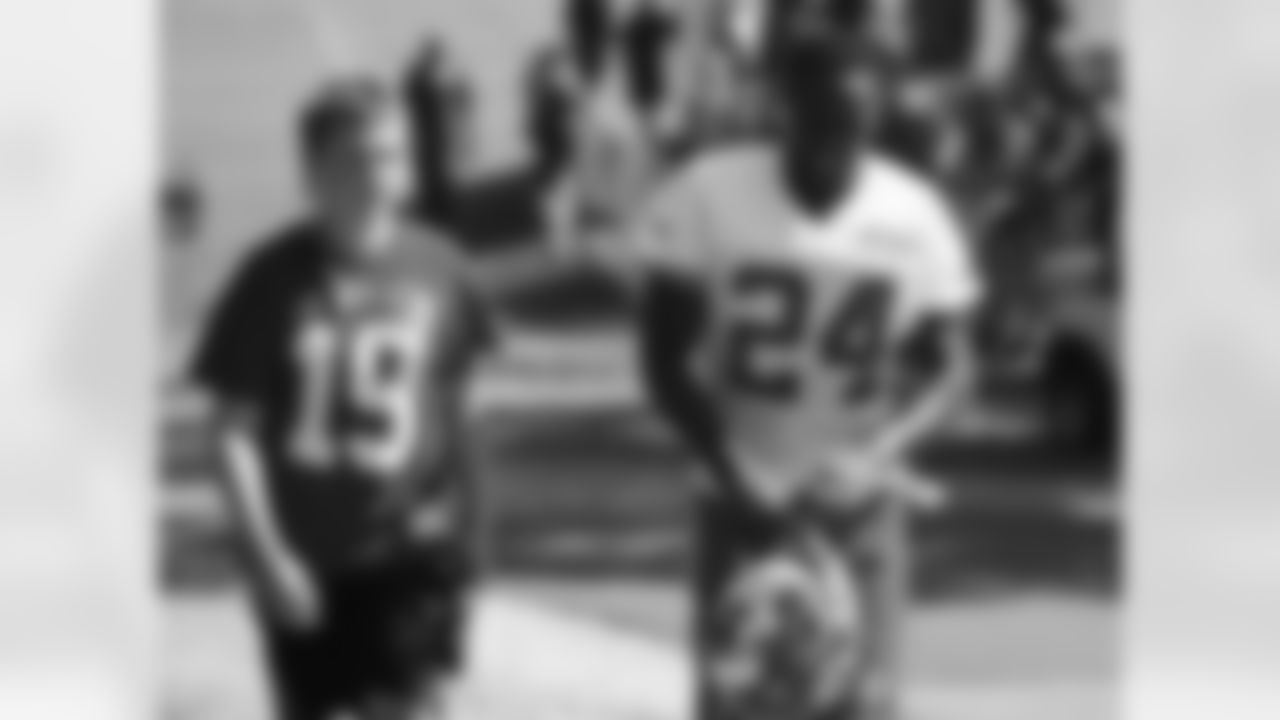 Kansas City Chiefs defensive back D.J. White (24) walks with a young fan after practice on the fourteenth day of training camp on Mosaic Life Care Field at the campus of Missouri Western State University on Wednesday, August 17, 2016.