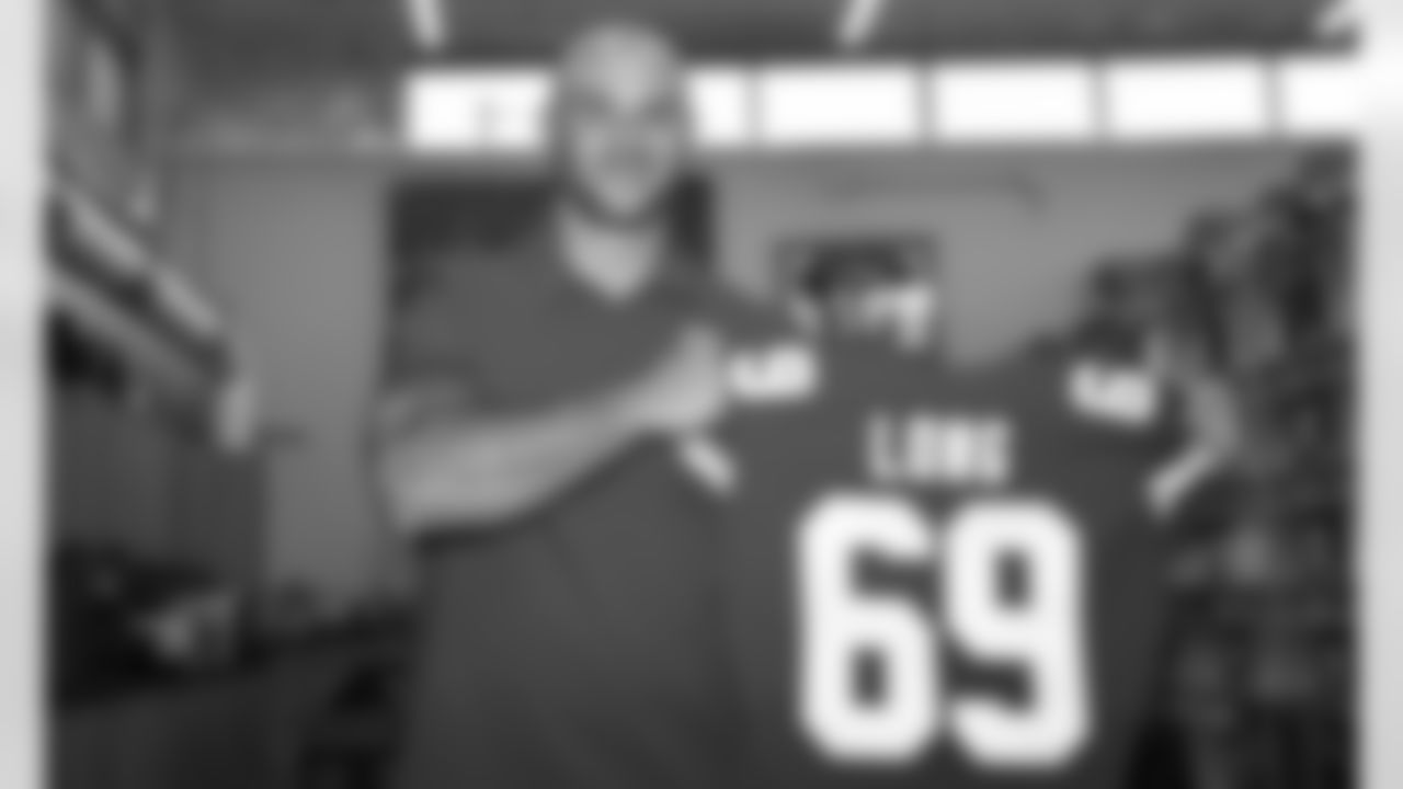 Kyle Long poses for a photo with his new jersey.