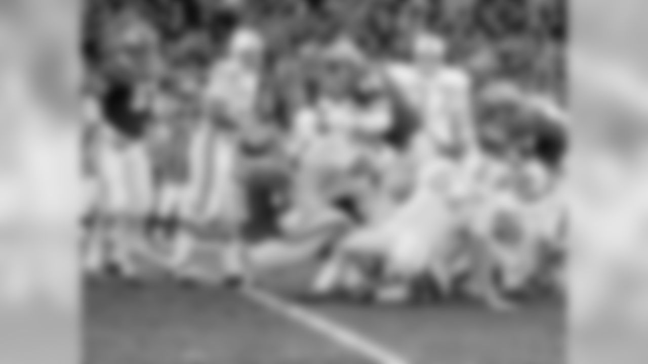 Miami's Jim Kiick (21) is hauled up by short Kansas City's Curley Culp (61) and Buck Buchanan (86) for no gain in the first quarter of the play-off game Dec. 25, 1971 in Kansas City.