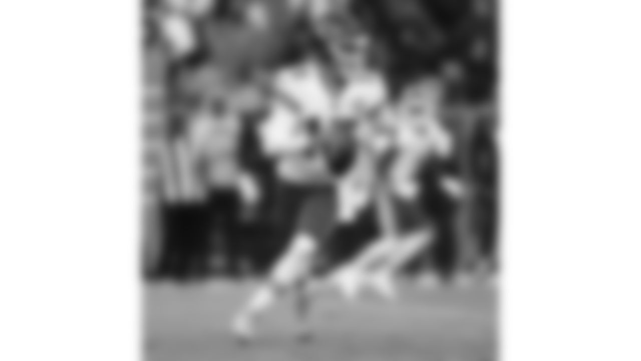 Kansas City Chiefs quarterback Patrick Mahomes (15) rolls out to pass during an NFL football game against the Denver Broncos, Sunday, December 11, 2022 in Denver.