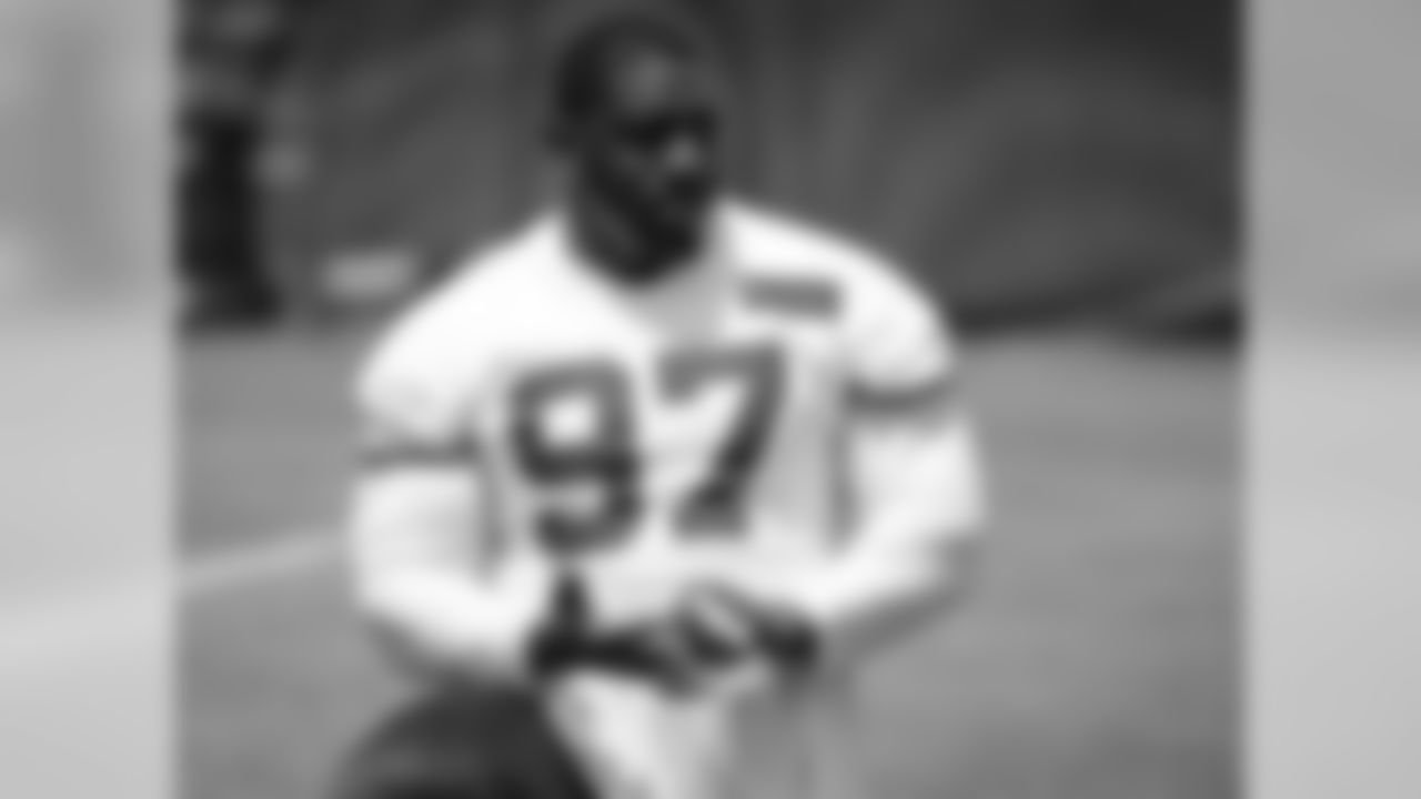Kansas City Chiefs defensive lineman Allen Bailey (97) removes tape from his fingers at the end of practice on day two of the third week of OTA's