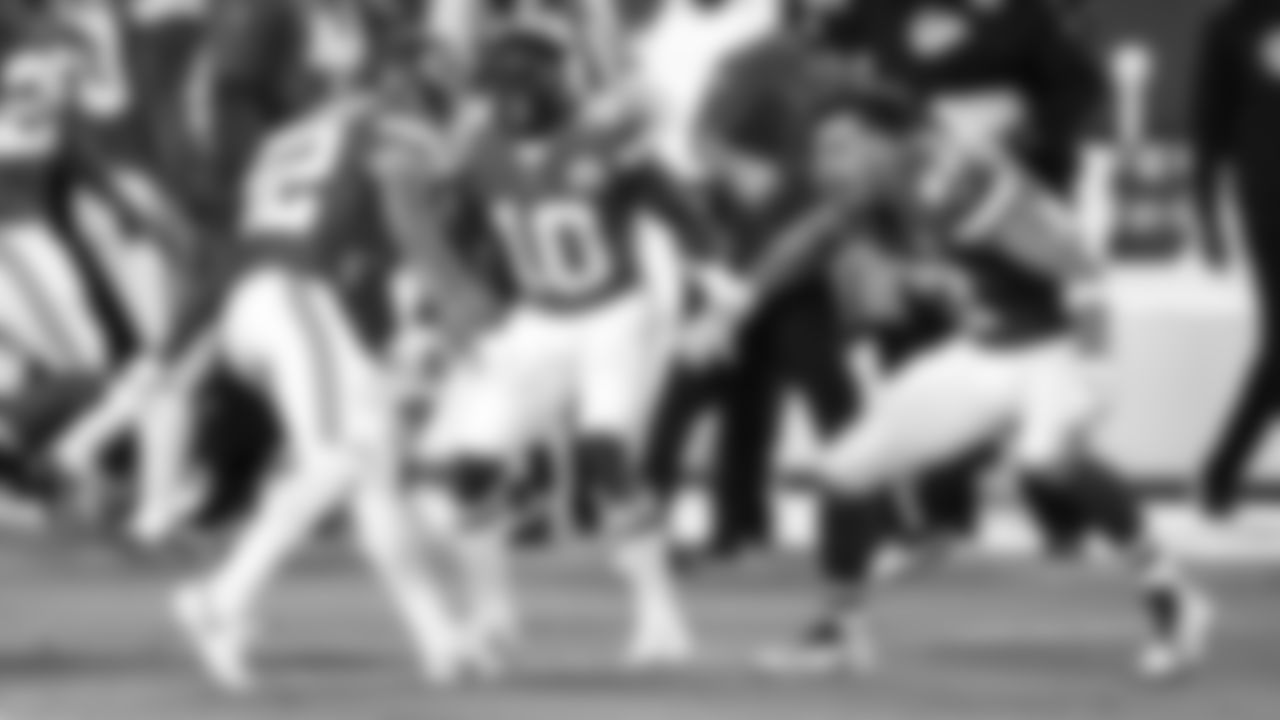 Kansas City Chiefs strong safety Tyrann Mathieu (32) is met by an excited Chiefs tight end Travis Kelce (87) and Chiefs wide receiver Tyreek Hill (10) on the sideline during an NFL football game against the New England Patriots, Monday, Oct. 5, 2020 in Kansas City.