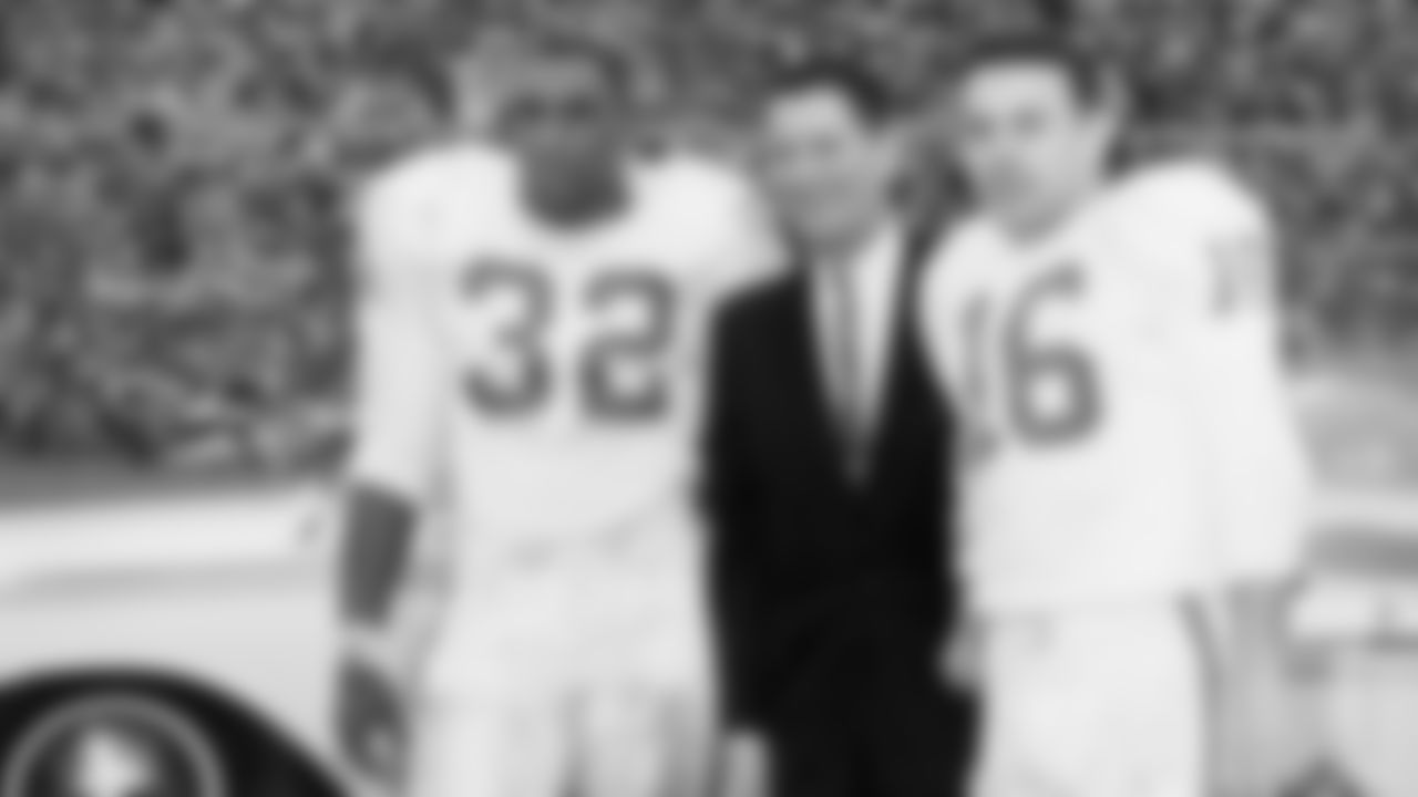 AFL Commissioner Joe Foss stands with Dallas Texans fullback Curtis McClinton (32) and Hall of Fame quarterback Len Dawson (16) following the AFL Championship Game, a 20-17 victory over the Houston Oilers on December 23, 1962, December 23, 1962.