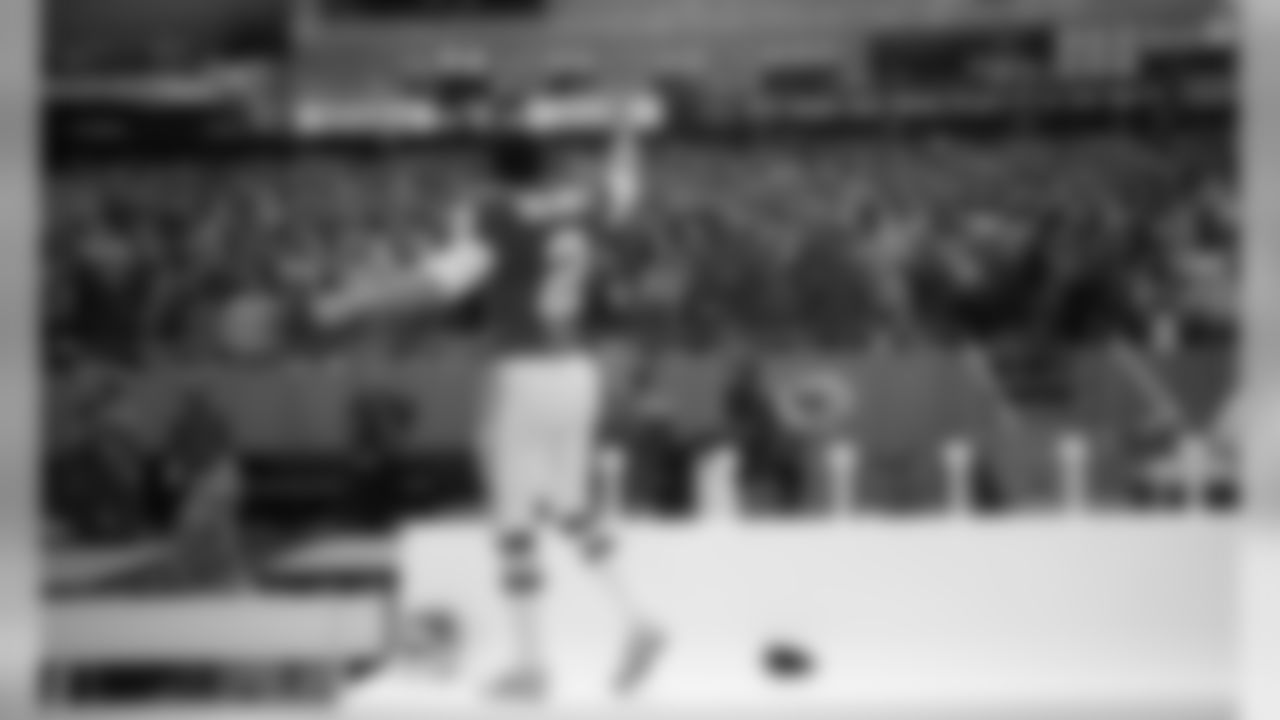 Kansas City Chiefs punter Dustin Colquitt (2) stands on the bench and celebrates on the sideline during a 2006 home game.