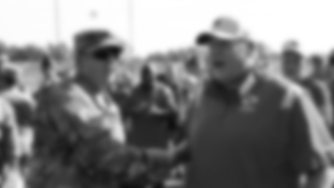 Sergeant First Class Jeremy Enriquez from the U.S. Army receives a game ball from Kansas City Chiefs Head Coach Andy Reid after training camp practice at Missouri Western State University.