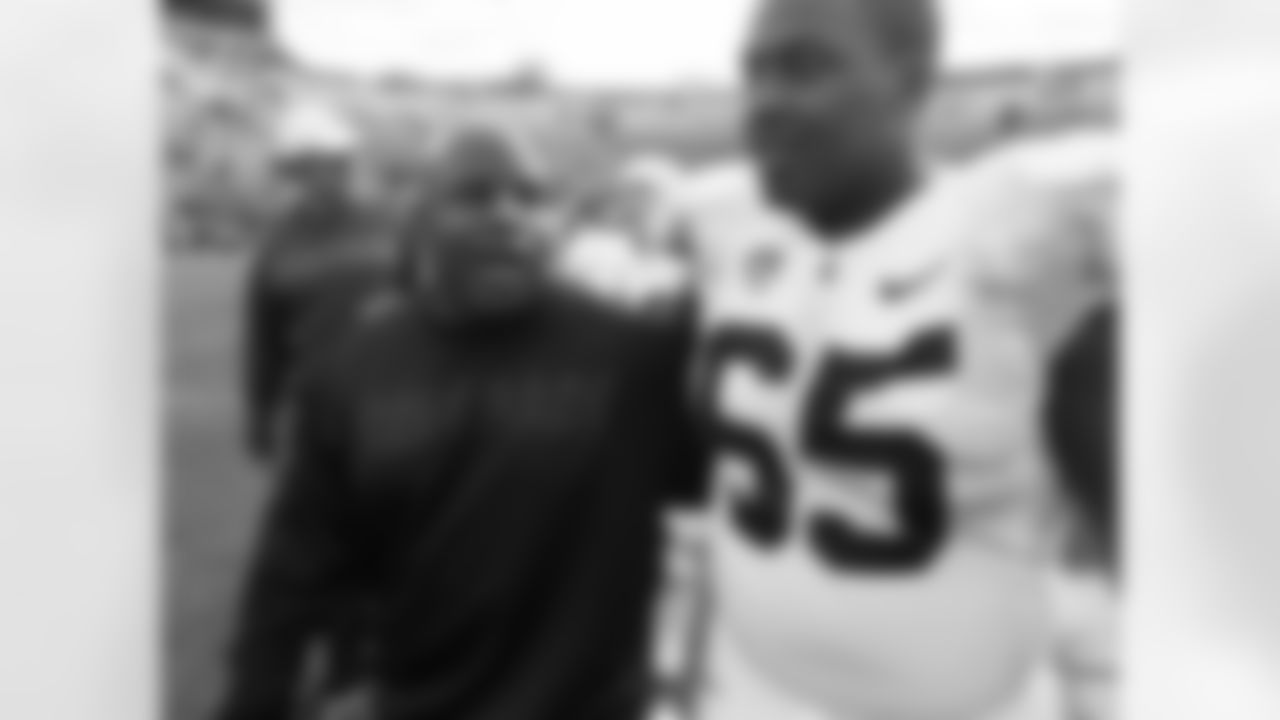 Colorado offensive coordinator Eric Bieniemy, left, greets Stanford offensive guard Khalil Wilkes after Stanford's 48-0 victory in an NCAA college football game in Boulder, Colo., on Saturday, Nov. 3, 2012.