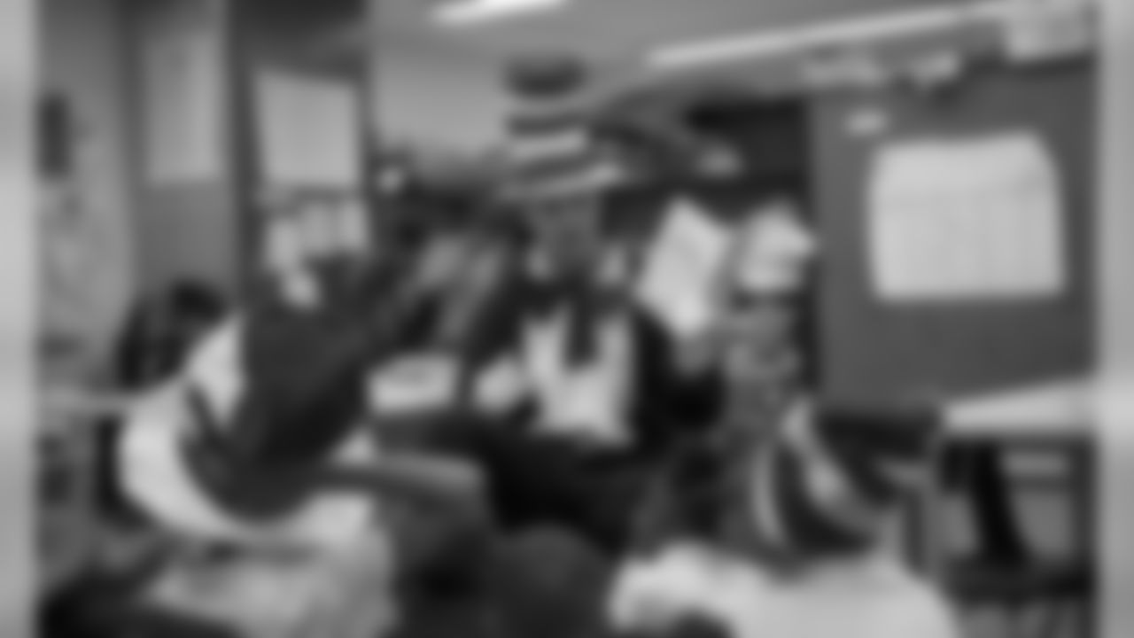 Kansas City Chiefs punter Dustin Colquitt (2) reads to children at a school in 2009.