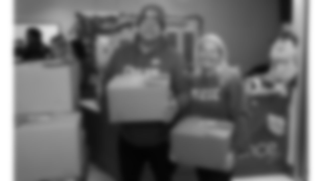 Kansas City Chiefs fans help Derrick Nnadi & Slap's BBQ give away 150 Thanksgiving meals to families at the Independence Boys and Girls Club, Monday, November 21, 2022.