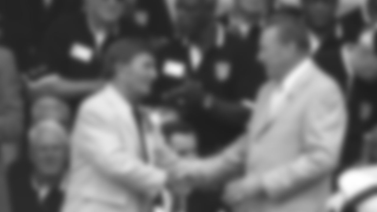Hank Stram and Len Dawson shake hands at Stram's 2013 Hall of Fame induction.