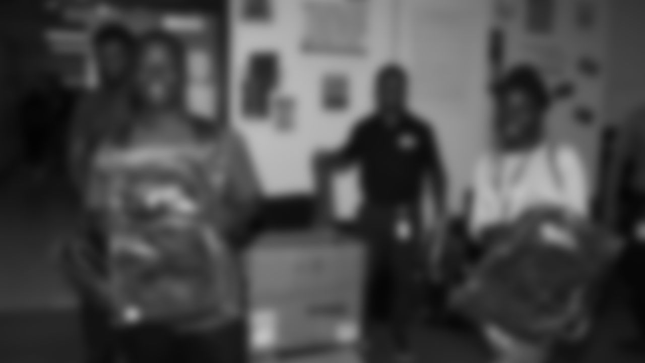 East High School seniors receive Kansas City Chiefs backpacks after linebacker Nick Bolton (32) and safety Justin Reid (20) spoke to their Senior Seminar class about the importance of continuing education.