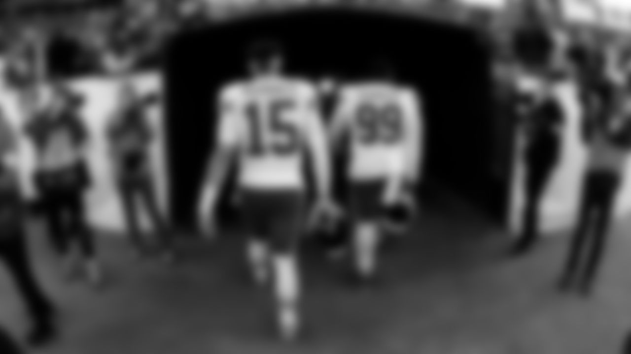 Kansas City Chiefs quarterback Patrick Mahomes (15) and defensive tackle Khalen Saunders (99) walk into the tunnel prior to an NFL football game against the Denver Broncos, Sunday, December 11, 2022 in Denver.