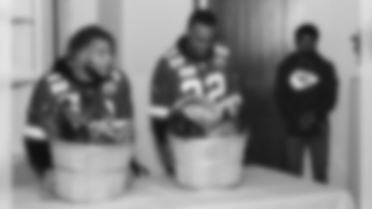 Chiefs players and representatives from KC Southern make a surprise visit to a local family at the Guadalupe Center.