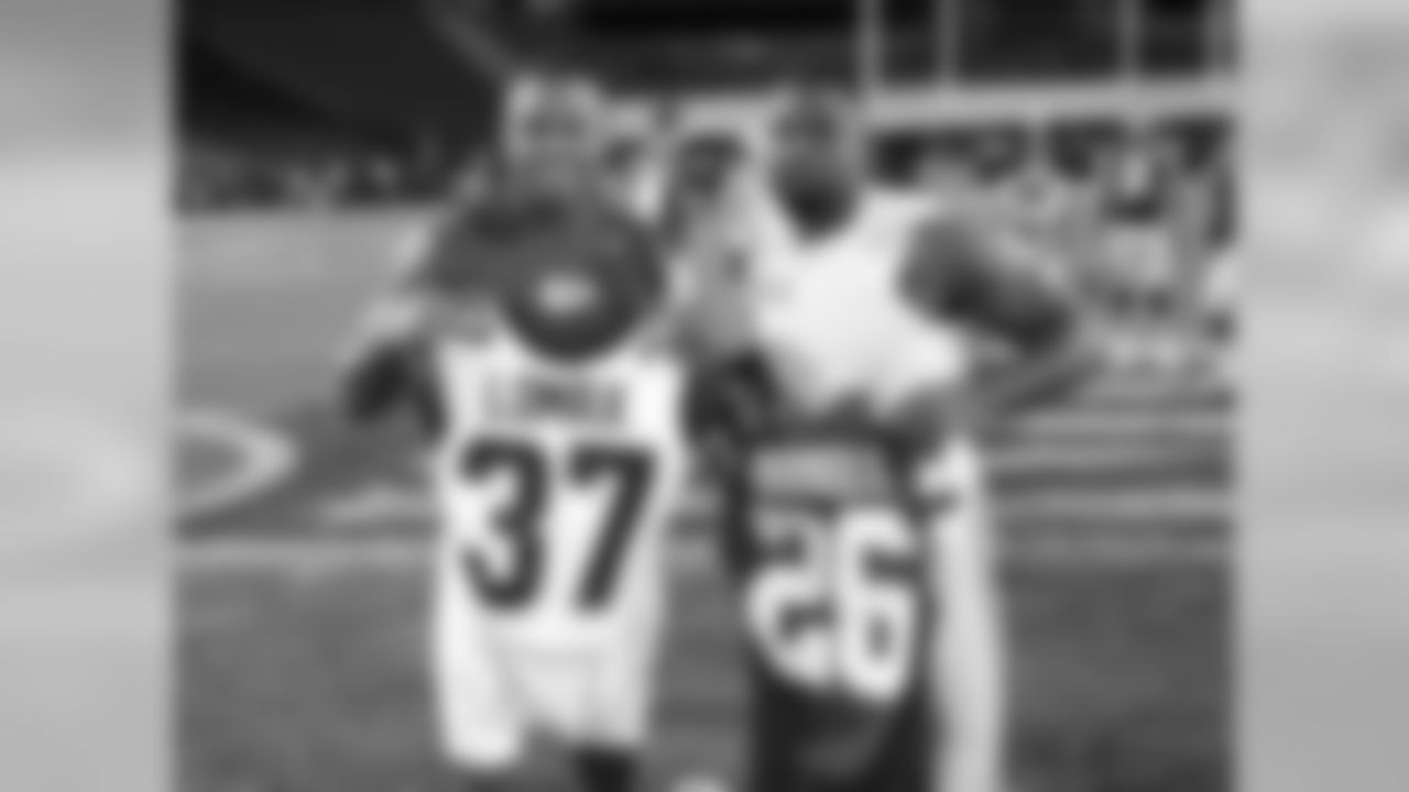 Kansas City Chiefs defensive back KeiVarae Russell (26) and Los Angeles Rams defensive back Jordan Lomax (37) exchange jerseys after the preseason game at the Los Angeles Memorial Coliseum on Saturday, August 20, 2016.