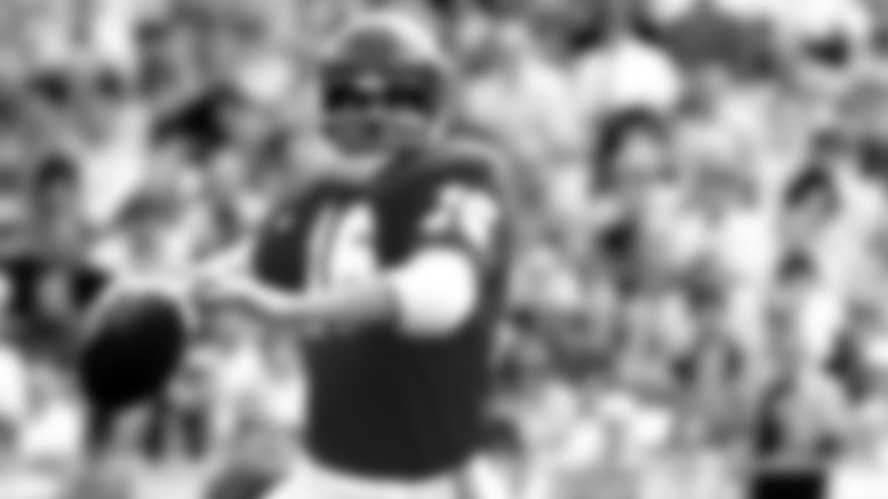 Len Dawson (16) rolls out to pass.
