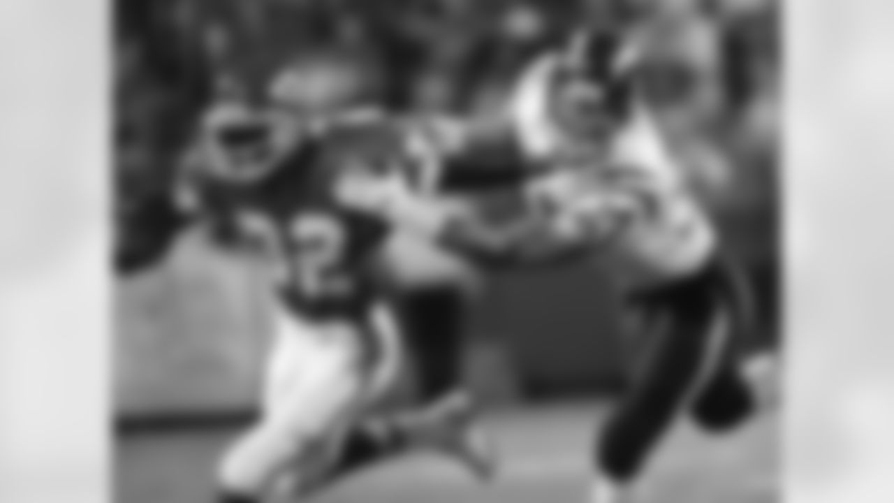 Chiefs running back Marcus Allen tries to keeps some distance from San Diego Chargers inside linebacker Dennis Gibson during the first quarter on October 9, 1995.