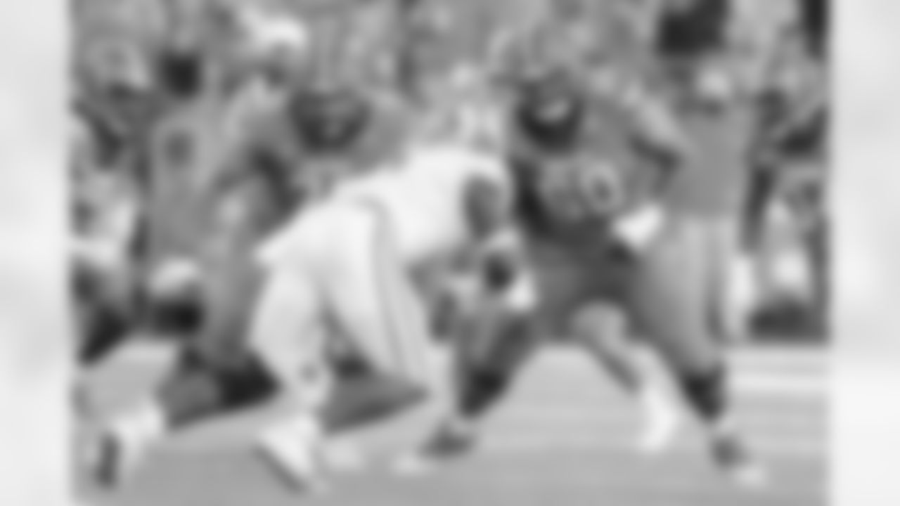 Syracuse offensive lineman Kalan Ellis (76) and offensive lineman Matthew Bergeron (60) move to block Clemson defensive end K.J. Henry (5) during the first quarter of their NCAA football game in Syracuse, N.Y., Friday, Oct. 15, 2021. (AP Photo/Joshua Bessex)