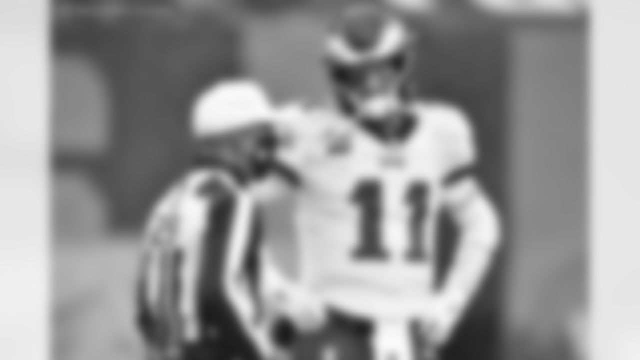 Philadelphia Eagles quarterback Carson Wentz (11) talks with referee Adrian Hill before an NFL football game against the Cleveland Browns, Sunday, Nov. 22, 2020, in Cleveland. (AP Photo/David Richard)