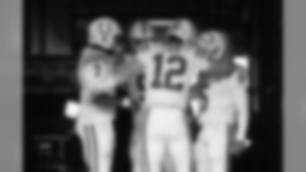 Indianapolis Colts quarterback Andrew Luck (12) hugs quarterback Phillip Walker (5) in the tunnel as he huddles with quarterbacks Jacoby Brissett (7) and Brad Kaaya (9) passes before taking the field for warmups before an NFL football preseason game against the Seattle Seahawks, Thursday, Aug. 9, 2018, in Seattle. (AP Photo/Stephen Brashear)