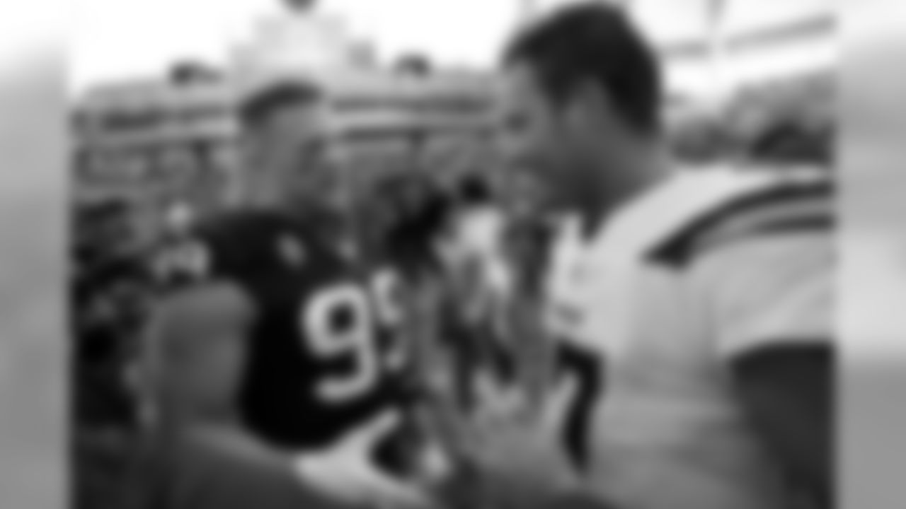 Houston Texans defensive end J.J. Watt, left, and Los Angeles Chargers quarterback Philip Rivers shake hands after an NFL football game Sunday, Sept. 22, 2019, in Carson, Calif. (AP Photo/Mark J. Terrill)