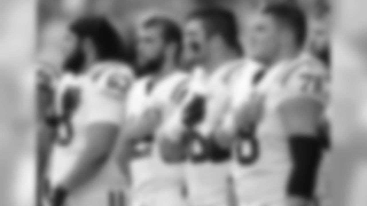 Indianapolis Colts players, including quarterback Andrew Luck, second from left, stand during the singing of the national anthem before an NFL football preseason game against the Seattle Seahawks, Thursday, Aug. 9, 2018, in Seattle. (AP Photo/Stephen Brashear)