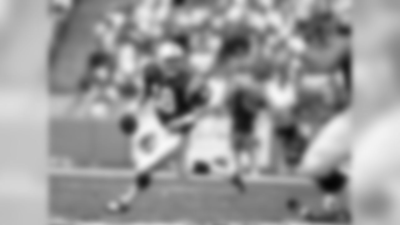Indianapolis Colts quarterback Peyton Manning (18) runs the ball as he looks to throw a pass during an NFL game against the Miami Dolphins Dec. 5, 1999, in Miami Gardens, Fla. The Colts defeated the Dolphins 37Ð34. (Allen Kee via AP)