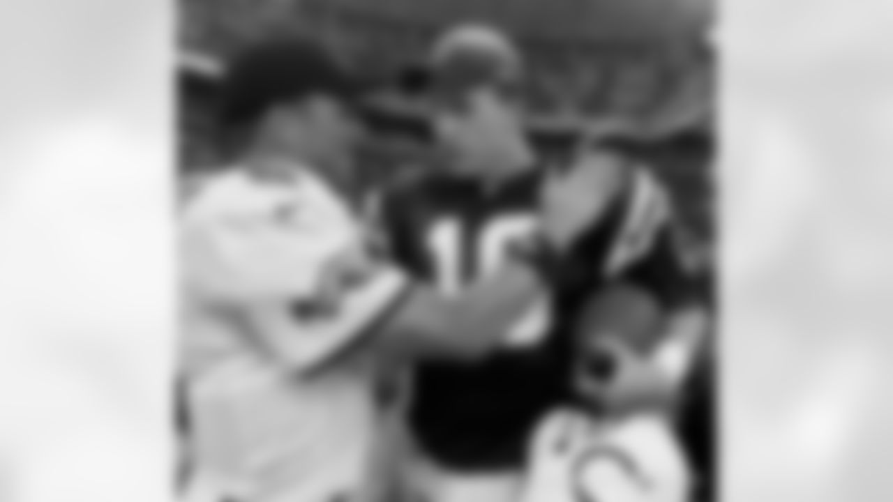 Indianapolis Colts quarterback Peyton Manning, right, is congratulated by Jacksonville Jaguars quarterback Mark Brunell, after the Colts' won 43-14, Monday night, Sept. 25, 2000. Manning passed for a franchise-record 440 yards and threw for four touchdowns. (AP Photo/Tom Strattman)