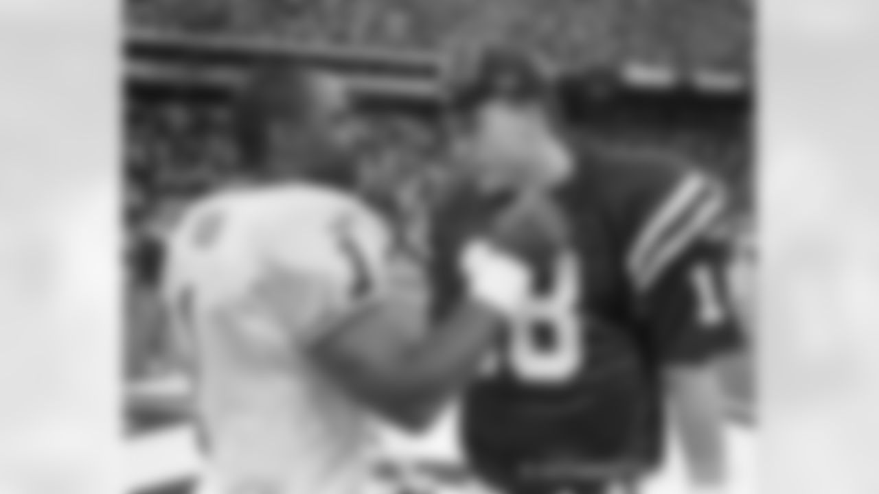 Indianapolis Colts quarterback Peyton Manning, right, is congratulated by Kansas City Chiefs quarterback Warren Moon following their game in Indianapolis on Sunday, Nov. 7, 1999. The Colts defeated the Chiefs 25-17 as Manning threw for 290 yards and scored one rushing touchdown. (AP Photo/Michael Conroy)